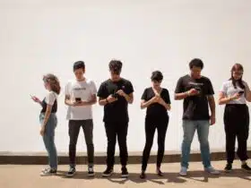 group of people standing on brown floor