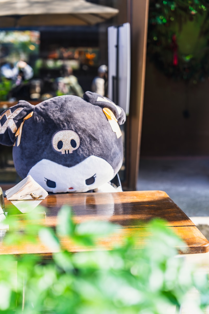 a stuffed animal sitting on top of a wooden table