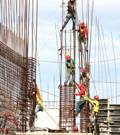 people working on building during daytime