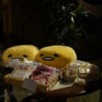 a table topped with stuffed animals and baskets of food